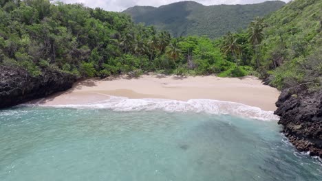 Top-view-of-waves-crashing-towards-the-shore-of-Playa-Onda-Samana-In-Dominican-Republic---drone-shot