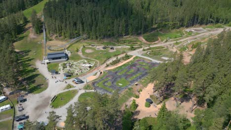 Aerial-Fly-Over-of-Isaberg-Mountain-Resort-in-Sweden-Showing-Mini-Golf-Course-and-Pump-Track
