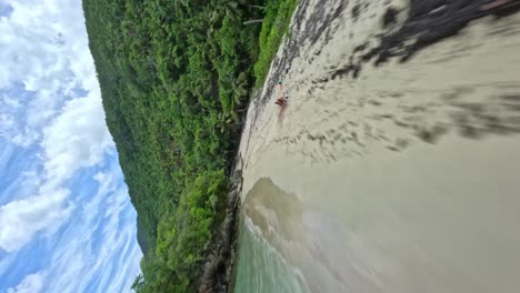 FPV-shot-on-Playa-Ermitaño-coast-in-Samana,-Dominican-Republic--vertical-view