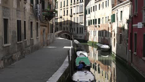 Empty-Street-Beside-Venice-Canal-With-Row-Of-Boats-Moored