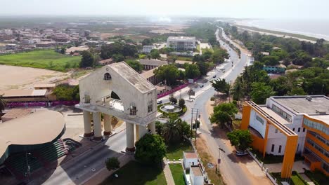 Cinematic-drone-view-flying-towards-22-nd-July-Arch-at-Banjul-entrance,-The-Gambia---West-Africa