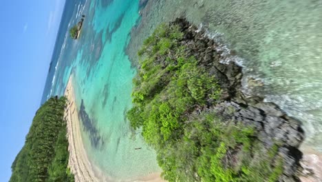 FPV-shot-on-Playa-Ermitaño-sea-in-Samana,-Dominican-Republic--vertical-view