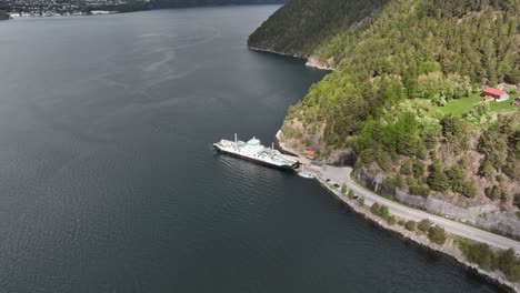 Norway-Infrastructure---Ferry-named-Volda-leaving-port-of-Liabygda-towards-Stranda-in-More-and-Romsdal---High-angle-aerial-view