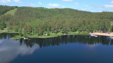 Stunning-Aerial-Shot-of-Forest-and-Lake-at-Isaberg-Mountain-Resort-in-Sweden