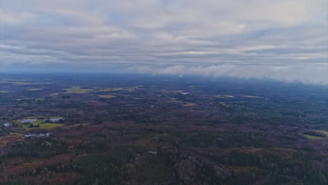 High-aerial-panoramic-view-over-a-mixed-landscape-with-forest-and-fields