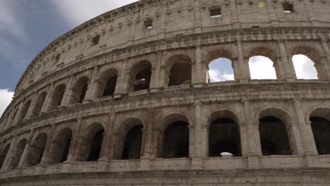 A-sunny-morning-with-the-Colosseum-in-Rome-where-the-beautiful-clouds-in-the-blue-sky-are-in-the-background