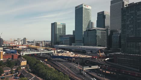 London,-England-UK,-Aerial-View-of-Busy-Daily-Traffic,-Cars-on-Roads-and-Trains-on-Railways-Under-Modern-Buildings,-Cinematic-Drone-Shot