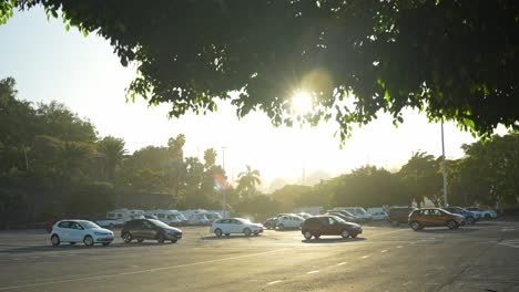 Establishing-shot-of-parking-lot-with-few-cars-and-campers-in-Santa-Cruz,-sunny