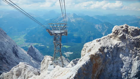From-the-hilltop,-you'll-have-an-incredible-view-of-chairlifts-gliding-through-the-wires-and-the-breathtaking-mountain-range