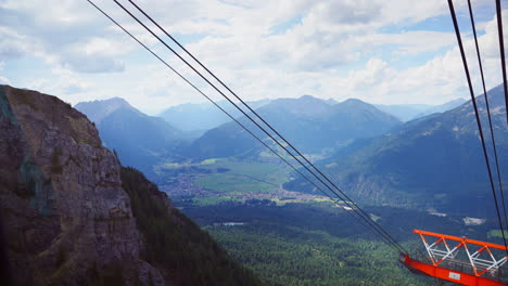 From-the-top-of-the-hill,-you-can-enjoy-a-delightful-view-of-the-chairlifts,-cables,-and-the-stunning-mountain-range