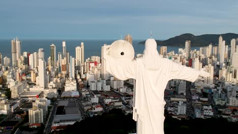Aerial-view-pane-right-of-Christ-the-remeeder-in-Balneario-Camboriu,-Brazil-with-the-city-and-beach-on-the-background