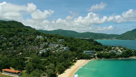 4K-Cinematic-nature-aerial-footage-of-a-drone-flying-over-the-beautiful-beach-of-Surin-in-Phuket,-Thailand-on-a-sunny-day