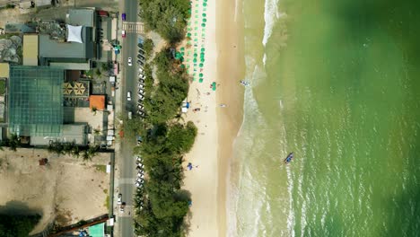 4K-Cinematic-nature-aerial-footage-of-a-drone-flying-over-the-beautiful-beach-of-Patong-in-Phuket,-Thailand-on-a-sunny-day