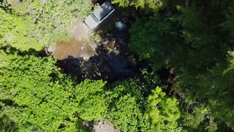driving-ford-bronco-on-ballast-in-the-forest,-drone-video