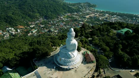 4K-Cinematic-nature-aerial-footage-of-a-drone-flying-over-the-Big-Buddha-on-top-of-the-mountains-in-Phuket,-Thailand-on-a-sunny-day