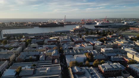 Aerial-flyover-Fremantle-Port-with-ship-and-industry-during-sunset-time-on-Perth-City---Establishing-drone-flight