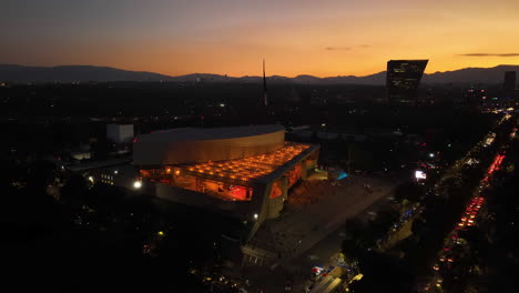 Aerial-view-toward-the-entrance-of-the-Auditorio-Nacional,-night-in-Mexico-city