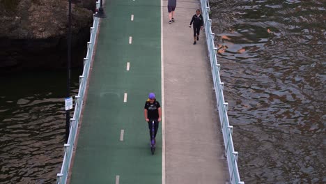 Urban-bicentennial-bikeway,-an-active-transport-superhighway-running-alongside-Brisbane-River-for-safe-walking,-bike-riding-and-scooting,-static-shot-capturing-Australian-living-lifestyle
