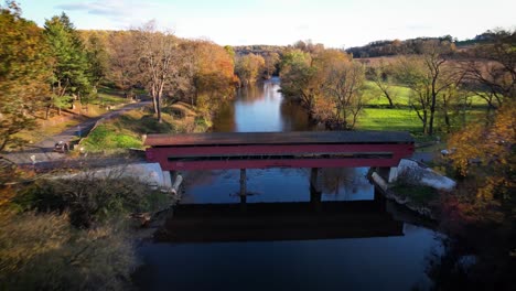 River-valley-covered-bridge-drone-autumn-leaves-flyover