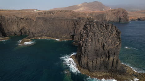 Roque-Partido,-Gran-Canaria:-Fantastic-aerial-view-at-very-close-range-and-in-a-circle-to-the-rock-formation-called-Roque-Partido-on-the-island-of-Gran-Canaria-and-on-a-sunny-day