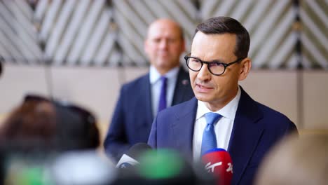 Prime-Minister-of-Poland-Mateusz-Morawiecki-giving-an-interview-during-the-European-Council-summit-in-Brussels,-Belgium---Slow-motion-shot