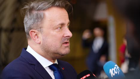 Prime-Minister-of-Luxembourg-Xavier-Bettel-giving-an-interview-during-the-European-Council-summit-in-Brussels,-Belgium---Profile-shot