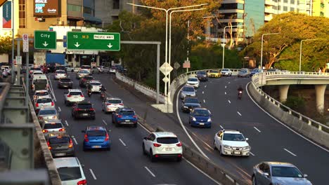 Handheld-motion-shot-capturing-heavy-vehicle-traffics-on-M3-Pacific-Motorway,-cars-driving-into-Brisbane-city,-bottleneck-traffic-on-North-Quay-and-riverside-expressway