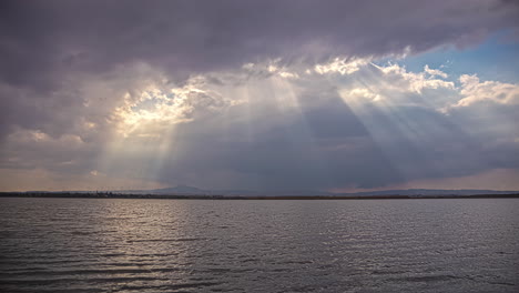 Sunbeams-shine-through-the-clouds-over-the-Larnaca-Salt-Lake-in-Cyprus---time-lapse