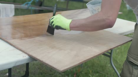 Applying-Epoxy-coating-over-a-sheet-of-plywood
