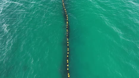 Aerial-flyover-protective-shark-net-in-ocean-of-Australia-protecting-tourist-for-sharks
