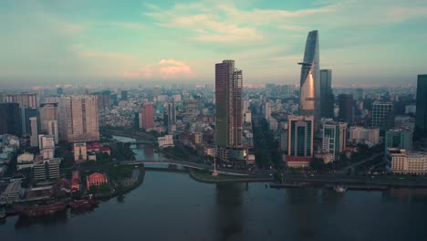 Panning-drone-shot-of-Saigon-River-and-Ho-Chi-Minh-City-Skyline-at-dawn-featuring-all-key-buildings