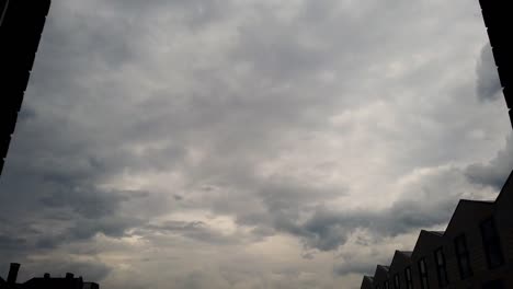Dramatic-timelapse-shot-from-an-apartment-window,-sky-darkening-just-before-rain