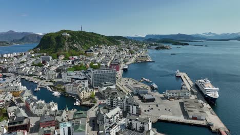 Summer-day-in-Alesund-Norway---Aerial-above-city-center-surrounded-by-ocean-and-Aksla-mountain-in-middle-background