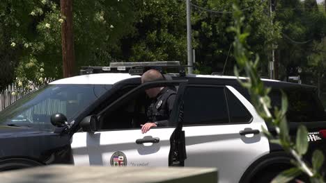 police-officer-stands-by-patrol-car