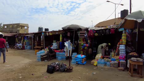 Panoramic-and-walk-through-view-of-small-African-market-at-Banjul-ferry-terminal,-Gambia-Ports-Authority