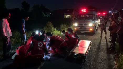 Indonesia---Jun-30,-2023-:-Indonesia-Red-Cross-or-Palang-Merah-Indonesia-Officers-are-evacuating-the-victims-of-the-accident-on-the-road