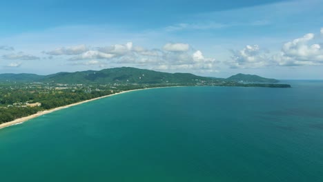 4K-Cinematic-nature-aerial-footage-of-a-drone-flying-over-the-beautiful-beach-of-Bang-Tao-in-Phuket,-Thailand-on-a-sunny-day