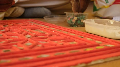 scene-from-the-ground-in-which-one-craftsman-after-another-is-pasting-chandeliers-into-his-old-traditional-mudwork-paintings