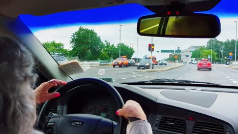 4K-60FPS-Elderly-Woman-is-Driving-a-Car-in-City-Traffic---Handheld-Shot