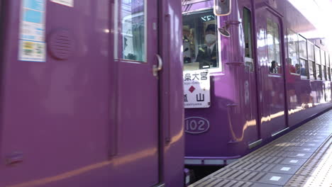 KYOTO,-JAPAN---April-4,-2023:-Randen-train-approaching-Arashiyama-Station