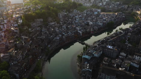 Aerial-view-tilting-over-the-Fenghuang-County,-Phoenix-ancient-city,-sunrise-in-China