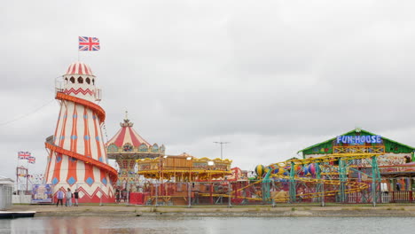 A-british-fairground-and-and-boating-lake-with-funhouse