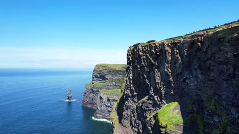 Low-drone-view-of-rocky-Cliffs-of-Moher-and-sea-stack-on-sunny-day