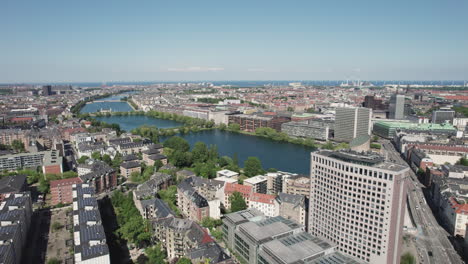 Copenhagen-from-above,-with-the-lakes,-vibrant-city-center,-and-bustling-office-buildings-in-a-beautiful-aerial-view