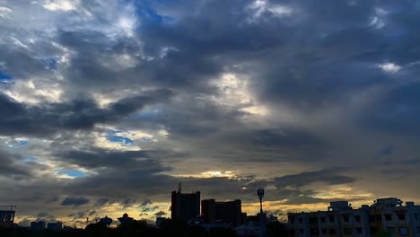 Timelapse-of-Heavy-dark-storm-raining-clouds-over-the-sky,-Dramatic-clouds-over-Surat-city,-Dramatic-clouds,-buildings-and-streets