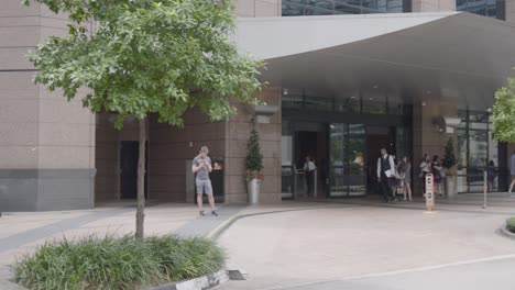 Wide-shot:-Camera-pans-from-a-Singapore-street-sign-to-a-hotel-entrance