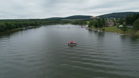 Pontoon-boat-drone-on-cloudy-day-on-lake-Deep-Creek-Lake-Maryland