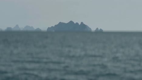 Camera-moving-forward-of-beautiful-island-in-the-world,-Gulf-of-Oman-horizon,-Island-at-sunset-in-the-ocean,-Blur-of-Background-Sky-and-Mountain