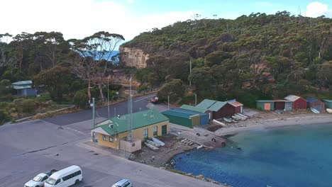 Pirates-Bay,-Tasmania,-Australia---12-March-2019:-Over-the-car-park-boat-ramp-and-boat-sheds-at-Pirates-Bay-Tasmania,-Australia