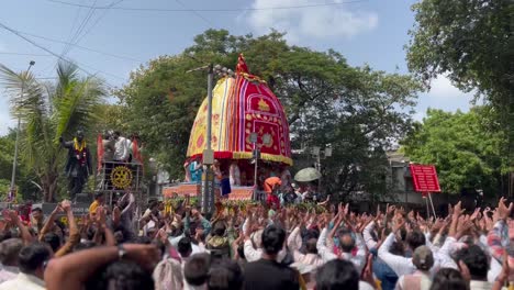 Cinematic-shot-of-The-Rath-Yatra-of-Lord-Jagannath-is-going-ahead-in-which-thousands-of-devotees-are-joining-and-raising-both-their-hands-to-see-the-Lord